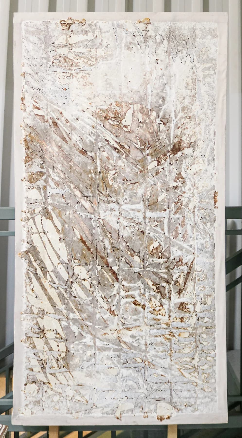 Vertical panel that is almost entirely white, with fine raised lines and a faint grid-like relief.