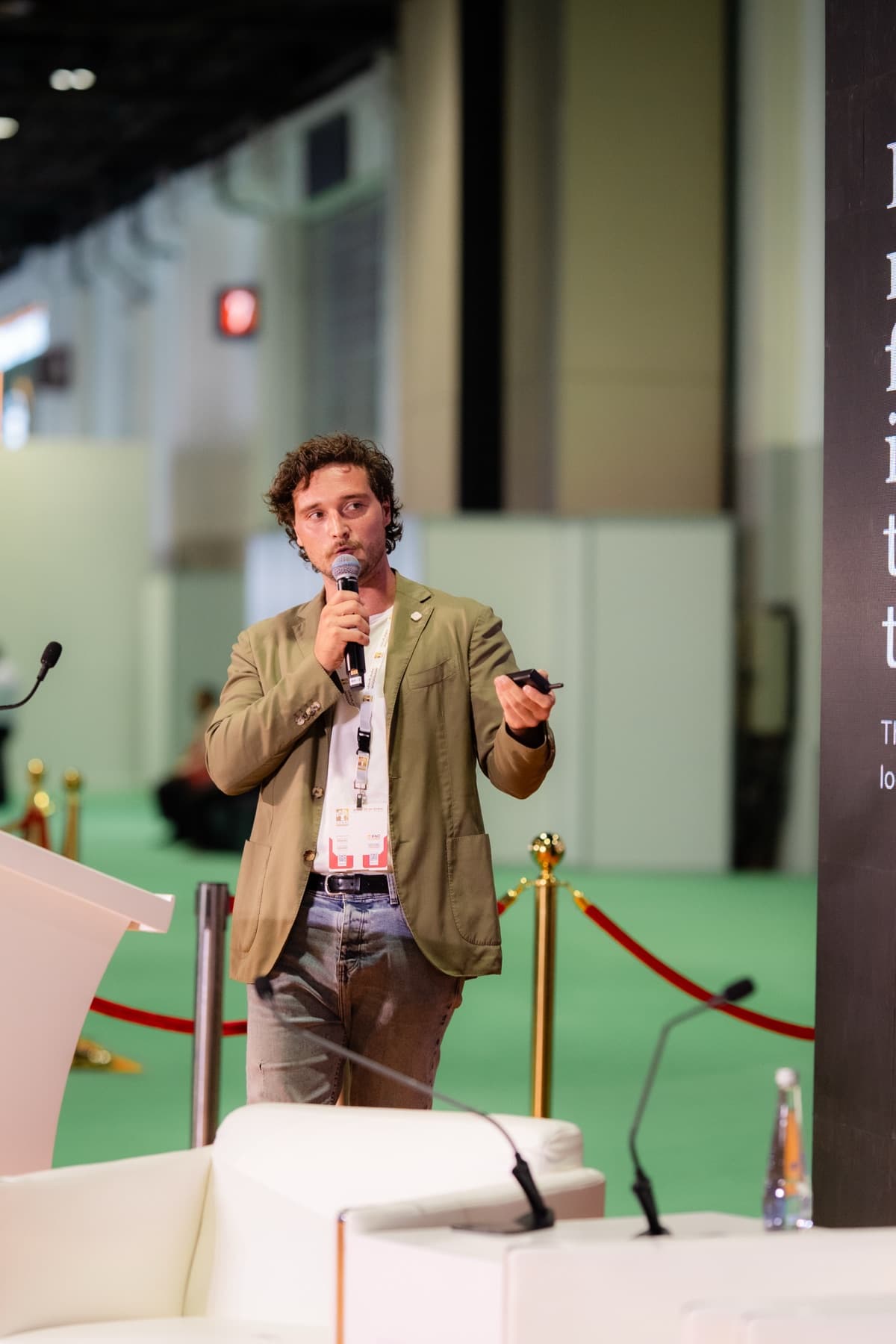Andy Cartier speaking with a microphone at Dubai WoodShow in June 2026